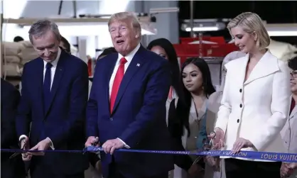  ??  ?? Donald Trump last week opens a new Louis Vuitton factory in Texas with Bernard Arnault, the chief executive of LVMH, and Ivanka Trump. Photograph: Andrew Harnik/AP