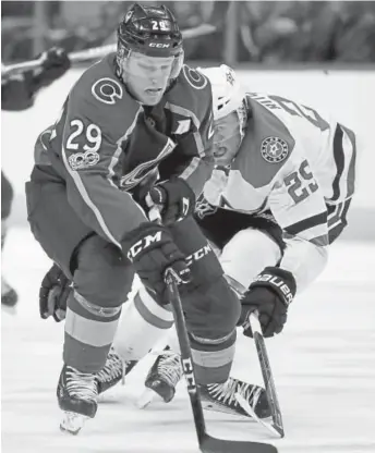  ?? The Associated Press ?? Avalanche center Nathan MacKinnon carries the puck past Stars right winger Brett Ritchie during Wednesday’s game at the Pepsi Center. MacKinnon had three assists in the 3-0 win.