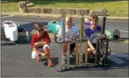  ??  ?? Winners, from left, Alejandro Vidal of the Stock division, Laura Lambert of the Superstock division and Gavin Brown of the Masters division pose with their trophies and cars after being announced the local winners. The three will go on to compete in...