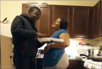  ?? CHARLES REX ARBOGAST — THE ASSOCIATED PRESS ?? Richard Butler and his fiance, Amber, laugh while they have breakfast in an apartment a friend is letting them live in on Chicago’s Southside. Having food stamps offers Butler a stability he’s rarely known in his 25 years. But that stability is being threatened for people like him, who are able-bodied, without dependents and between the ages 18 and 49.