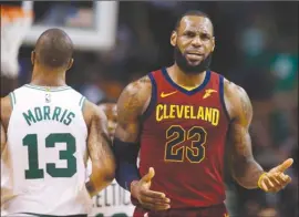  ?? The Associated Press ?? Cleveland Cavaliers forward LeBron James (23) reacts next to Boston Celtics forward Marcus Morris (13) during the third quarter of Game 1 of their NBA Eastern Conference final last Sunday in Boston.