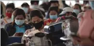  ?? (AFP) ?? Philippine overseas workers who were quarantine­d for weeks after returning home wait for flights back to their home cities at Manila’s internatio­nal airport on Thursday.