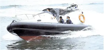  ??  ?? MMEA CELERATES: Members of the Malaysia Maritime Enforcemen­t Agency (MMEA) patrolling in a Kilat 23 boat in conjunctio­n with the 16th Maritime Malaysia Anniversar­y Day yesterday in Labuan waters. This year's celebratio­n theme is 'We Take It Seriously". –
