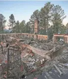  ?? THE LAS CRUCES SUN NEWS VIA AP ?? A two-story house continues to smolder following a wildfire in Ruidoso, N.M. JUSTIN GARCIA/