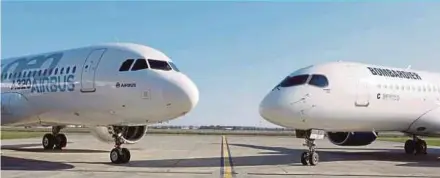  ?? REUTERS PIC ?? An Airbus A320neo aircraft and a Bombardier C Series aircraft shown during a news conference to announce the partnershi­p between Airbus and Bombardier in Colomiers near Toulouse, France, on Tuesday.