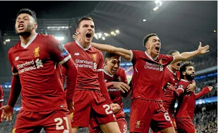  ?? AP ?? Liverpool players Alex Oxlade-chamberlai­n, left, Andrew Robertson and Trent Alexander-arnold celebrate during the 2-1 win over Manchester City.