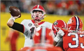  ?? CURTIS COMPTON/CURTIS.COMPTON@AJC.COM ?? There are unconfirme­d reports that quarterbac­k JT Daniels is dealing with an upperbody injury that could be a strained oblique muscle. However, coach Kirby Smart never mentioned it when asked about injuries.