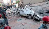  ?? —AP ?? A car is smashed under the weight of a building that collapsed in an earthquake in Kathmandu on Tuesday