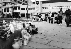  ?? ANDREA GJESTVANG / THE NEW YORK TIMES ?? People gather Thursday in Kongsberg, Norway, at a makeshift memorial to victims of a bow-and-arrow attack a day earlier. A 37-year-old man was charged on Thursday in connection with a rampage that killed five people in what the authoritie­s said was an apparent act of terrorism.