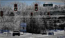  ?? MARSHALL GORBY / STAFF ?? Trees and lines sparkle as they are covered with ice on Upper Valley Pike on Sunday.