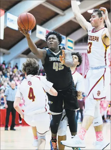  ?? David G. Whitham / For Hearst Connecticu­t Media ?? Trumbull’s Quentar Taylor drives to the hoop during the Eagle’s 85-81 victory over St. Joseph at Alumni Hall in Fairfield on Friday.