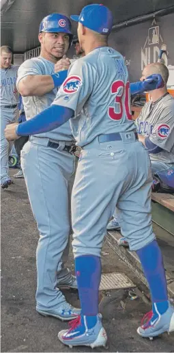  ??  ?? The Cubs’ Willson Contreras ( left) celebrates in the dugout with teammate Jon Jay after his home run in the second inning Saturday against the Nationals.
| AP