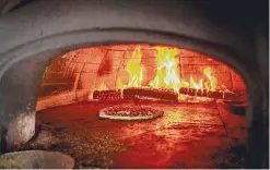  ?? Lisa Nichols / for Hearst Connecticu­t Media ?? Pizzas in the wood-fired oven at Brick & Basil Wood-Fired Pizza in Norwalk on July 28.