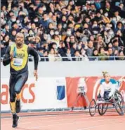  ??  ?? Usain Bolt (left), runs in a relay competitio­n during the opening event for the new National Stadium in Tokyo on Saturday.
AFP