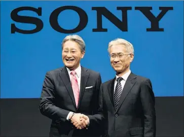  ?? Kazuhiro Nogi AFP/Getty Images ?? SONY CORP. Chief Executive Kazuo Hirai, left, shakes hands with Chief Financial Officer Kenichiro Yoshida at a news briefing Friday in Tokyo. Hirai oversaw a period that was at times turbulent for Sony.