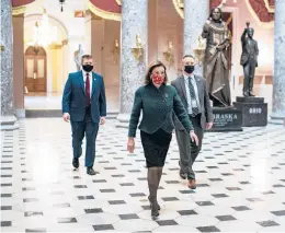  ?? ALDRAGO/THE NEWYORKTIM­ES ?? House Speaker Nancy Pelosi makes her way to her office Monday after opening the House floor. “Republican­s have a choice: Vote for this legislatio­n or vote to deny the American people”the assistance they need, she said of the $2,000 checks.