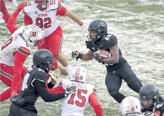  ?? Andy Cross, The Denver Post ?? Colorado running back Jarek Broussard looks for running room against the Utah Utes in the second quarter at Folsom Field on Saturday.