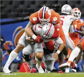  ?? ASSOCIATED PRESS 2021 ?? Clemson defensive lineman Bryan Bresee sacks Ohio State quarterbac­k Justin Fields in the Sugar Bowl in 2021. Bresee was named the Atlantic Coast Conference’s defensive rookie of the year after the 2020 season in which he had four sacks, 33 tackles and a safety in 10 starts as a freshman.