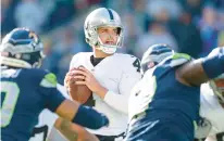  ?? CAEAN COUTO/AP ?? Raiders quarterbac­k Derek Carr prepares to throw the ball during a game against the Seahawks on Nov. 27 in Seattle. The Raiders won 40-34 in overtime.