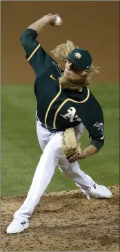  ?? JANE TYSKA — BAY AREA NEWS GROUP, FILE ?? A’s pitcher A.J. Puk (31) throws against the Giants in the seventh inning of their 2020 exhibition game at the Coliseum in Oakland.