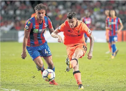  ??  ?? Liverpool’s Philippe Coutinho shoots at goal during their recent Premier League Asia Trophy match against Crystal Palace.