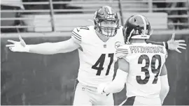  ?? NICK WASS/AP ?? Steelers linebacker Robert Spillane celebrates with free safety Minkah Fitzpatric­k after after scoring on a pick-six.