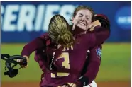  ?? (AP/Sue Ogrocki) ?? Florida State pitcher Kathryn Sandercock (right) celebrates with catcher Anna Shelnutt after the Seminoles defeated Oklahoma in the first game of the Women’s College World Series championsh­ip series Tuesday night in Oklahoma City.