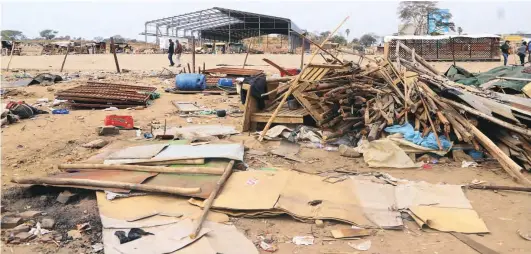  ??  ?? Vendors take down temporary structures at the corner of Seke and Dieppe roads to pave way for a new market being built by Harare City Council. Picture: Shepherd Tozvireva