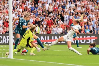  ?? The Associated Press ?? England’s Chloe Kelly scores the winning goal in the Women’s Euro 2022 final between England and Germany Sunday at Wembley Stadium in London.