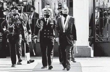  ?? HUGO CUROTTO/GETTY ?? New Peru president: A military guard escorts interim President Francisco Sagasti as he arrives Tuesday to take the oath of office at Congress in Lima, Peru. Lawmakers chose Sagasti as interim leader until the next presidenti­al elections scheduled for July 2021. Peru fell into turmoil last week when Congress voted to oust Martin Vizcarra. He later resigned.