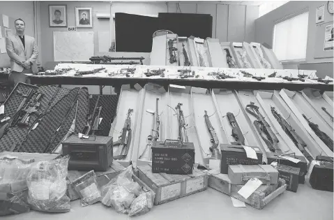  ?? PAUL CHIASSON / THE CANADIAN PRESS / FILE ?? Police in Longueuil, Que., display seized firearms. Criminals are using digital currency and creative shipping techniques to sell guns to Canadians.