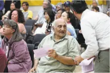  ??  ?? Behram Leskari of Pittsburg asks for a public comment slip so he can take his turn to speak during the community forum.