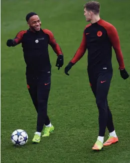  ?? — AFP ?? Manchester City’s Raheem Sterling (left) and John Stones at a training session in Manchester on Tuesday, the eve of their Champions League Round of 16 second-leg match against Monaco.