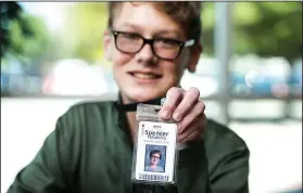  ?? NWA Democrat-Gazette/BEN GOFF • @NWABENGOFF ?? Sophomore Spencer Taliaferro shows his school identifica­tion badge Thursday at Bentonvill­e High School.