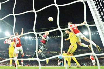  ?? — AFP photo ?? Sokratis scored Arsenal's decisive third goal to see them past BATE Borisov at the Emirates Stadium and into the Europa League last 16.