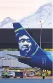  ?? TED S. WARREN AP ?? Alaska Airlines’ contract would give raises to many employees.