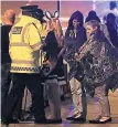  ??  ?? SURVIVORS Police help music fans as they leave after bombing