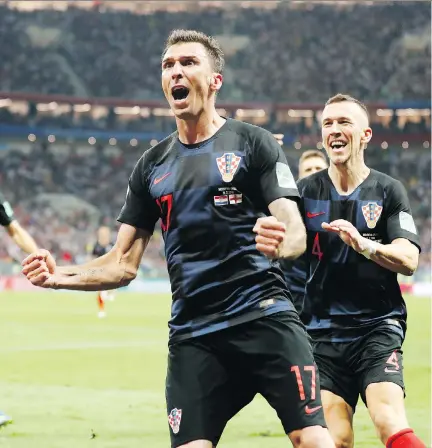  ?? FRANK AUGSTEIN/THE ASSOCIATED PRESS ?? Croatia’s Mario Mandzukic celebrates after scoring against England to break a 1-1 tie in extra time in Wednesday’s World Cup semifinal in Moscow. Croatia faces France in Sunday’s final.