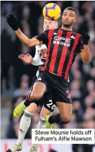  ??  ?? Steve Mounie holds off Fulham’s Alfie Mawson