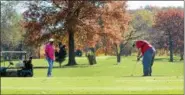  ?? NEWS-HERALD FILE ?? Jonnie and Brian Neibert finish their round on the ninth hole Nov. 4 at Johnnycake Ridge Golf Course in Mentor.