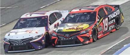  ?? JAMES GILBERT/GETTY IMAGES ?? Although Denny Hamlin, driver of the No. 11 FedEx Office Toyota, hasn’t won, he leads two-time winner Martin Truex Jr. (19) by 76 points in the Cup Series standings.