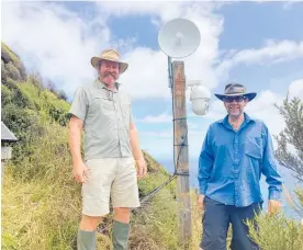  ?? ?? Volunteer John Wraight (left), and Daniel Bar-Even, from Groundtrut­h, with an upgraded Arapawaiti Point camera.