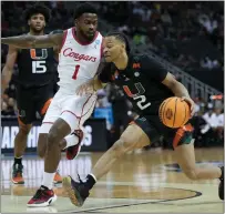  ?? JEFF ROBERSON — THE ASSOCIATED PRESS ?? Miami guard Isaiah Wong drives to the basket past Houston guard Jamal Shead in the first half of a Sweet 16 game in the Midwest Regional of the NCAA Tournament last Friday in Kansas City, Mo.