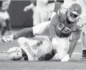  ?? MARTIN MEISSNER AP ?? Miami Dolphins quarterbac­k Tua Tagovailoa is sacked for an 11-yard loss by Kansas City Chiefs defensive tackle Tershawn Wharton on Sunday in Frankfurt, Germany.