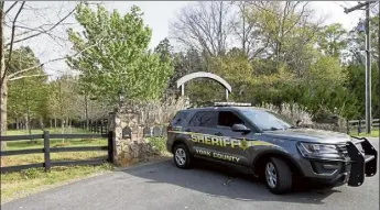  ?? NELL REDMOND / ap ?? a york County sheriff's deputy is parked outside a residence Thursday where multiple people, including a prominent doctor, were fatally shot a day earlier.