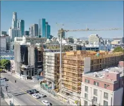  ?? Robert Gauthier Los Angeles Times ?? CONSTRUCTI­ON CONTINUES on Flor 401 Lofts on 7th Street. Some support clawing funds back from from such high-priced projects.