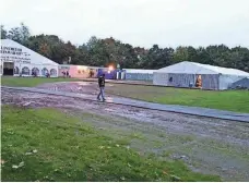  ?? JAMAL JABUR ?? A refugee walks near a temporary camp in Stuttgart, Germany.