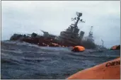  ?? THE ASSOCIATED PRESS ?? The Argentinia­n cruiser General Belgrano sinks amid orange life rafts holding survivors in the South Atlantic Ocean on May 1, 1982, after being torpedoed by the British Royal Navy.