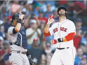  ?? Michael Dwyer / Associated Press ?? J.D. Martinez, right, celebrates his solo home run in front of Yankees catcher Austin Romine during the fourth inning Saturday.