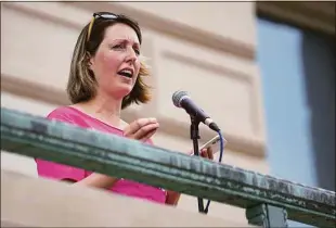  ?? Jenna Watson / Associated Press ?? Dr. Caitlin Bernard, a reproducti­ve health care provider, speaks during an abortion rights rally on June 25 at the Indiana Statehouse in Indianapol­is. The Indianapol­is doctor who performed an abortion on a 10-year-old rape victim from Ohio is suing Indiana's attorney general seeking to block him from using allegedly “frivolous” consumer complaints to issue subpoenas seeking patients' confidenti­al medical records.